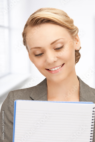 Photo: happy woman with big notepad happy woman with big notepad
