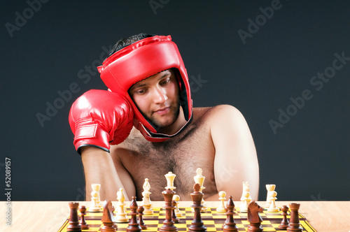 Photo: Boxer stuggling with chess game Boxer stuggling with chess game