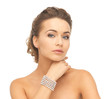 woman with pearl earrings and bracelet