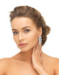 woman wearing shiny diamond earrings