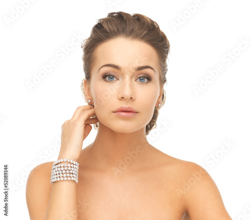 Photo: woman with pearl earrings and bracelet woman with pearl earrings and bracelet