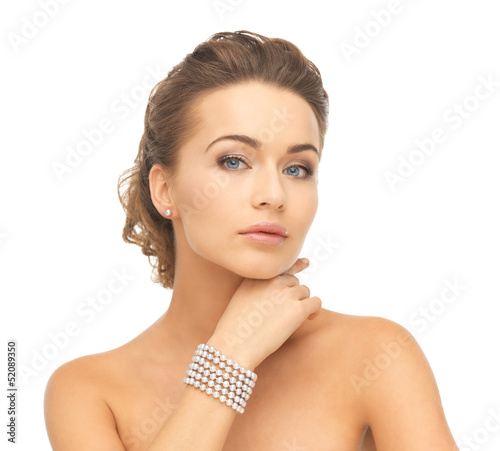 Photo: woman with pearl earrings and bracelet woman with pearl earrings and bracelet