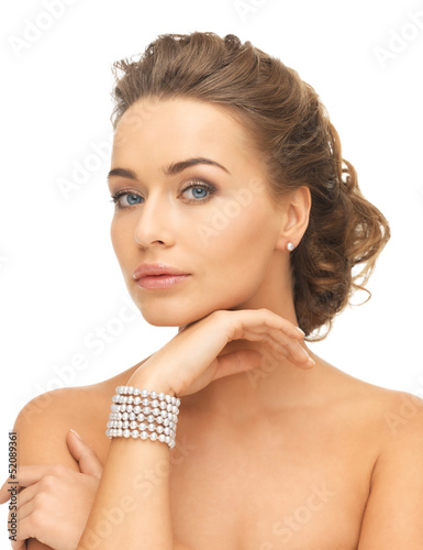 Photo: woman with pearl earrings and bracelet woman with pearl earrings and bracelet
