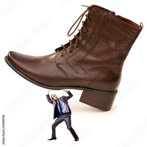 Photo: Woman domination concept with shoes and man Woman domination concept with shoes and man