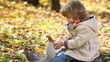 Video: Happy child feeds a little squirrel in autumn park Happy child feeds a little squirrel in autumn park