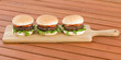 Hamburgers - Burgers in white buns with summer leaf and tomato.