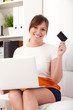 Photo: Closeup portrait of woman with a laptop and card Closeup portrait of woman with a laptop and card
