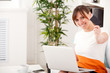 Photo: Closeup portrait of woman with a laptop and card Closeup portrait of woman with a laptop and card