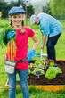 Photo: Gardening, planting - girl helping father in the garden Gardening, planting - girl helping father in the garden