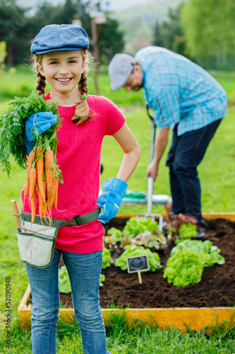 Photo: Gardening, planting - girl helping father in the garden Gardening, planting - girl helping father in the garden
