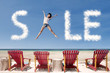 Photo: Advertising sale cloud and girl jump over beach chairs Advertising sale cloud and girl jump over beach chairs