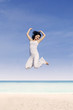 Beautiful woman jump at beach