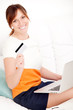 Foto: woman with card in hand and laptop woman with card in hand and laptop