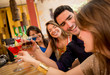 Happy friends having drinks