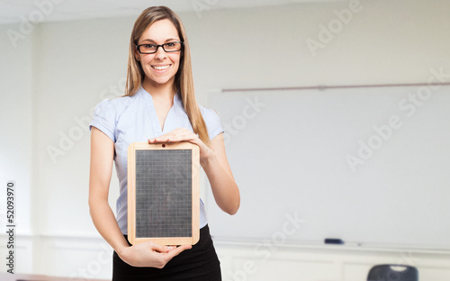 Photo: Woman holding a blackboard Woman holding a blackboard
