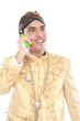 man with traditional java suit using mobile phone