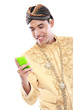 man with traditional java suit using mobile phone