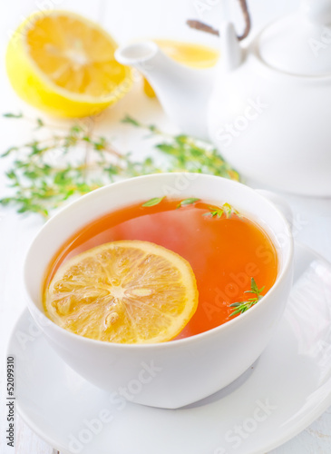 Photo: Fresh tea with lemon in the white cup Fresh tea with lemon in the white cup