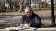 Man reading a book at the table