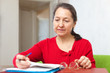 Mature woman reads documents