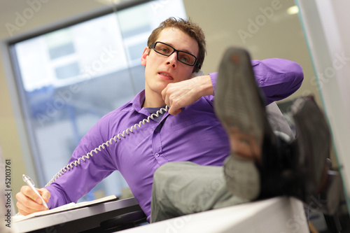 Photo: bad sitting posture - business man on phone bad sitting posture - business man on phone