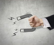 Photo: Businessman use magnet to attract Businessman use magnet to attract