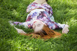 Beautiful girl lying down at grass.