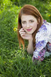 Beautiful girl lying down at grass.