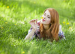 Beautiful girl lying down at grass.