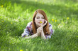 Beautiful girl lying down at grass.