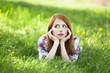 Beautiful girl lying down at grass.