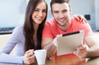 Happy couple with digital tablet