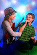 young girl playing guitar and boy singing