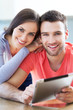 Happy couple with digital tablet