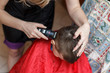 Haircut of little boy with machine