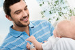 happy father playing with a baby