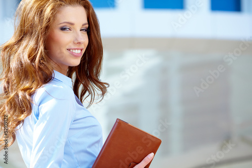Photo: Beautiful business woman on the background of the modern office Beautiful business woman on the background of the modern office