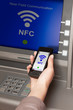 withdrawing money atm with mobile phone a NFC terminal
