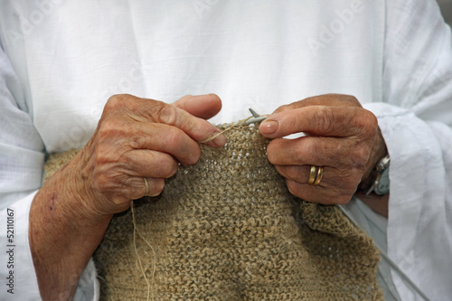 Photo: hands of an elderly woman during the processing of wool sweater hands of an elderly woman during the processing of wool sweater