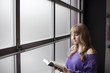 Young Woman in a Purple Shirt Reading a Book