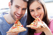 Couple eating pizza