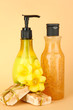 Liquid and hand-made soaps on beige background