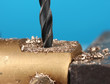 Photo: Drilling hole into metal, on color background Drilling hole into metal, on color background
