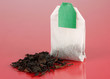 Tea bag on red background