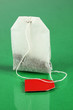 Tea bag on green background