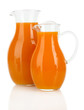Orange juice in pitchers isolated on white