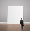 man looking at poster