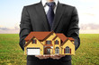 man holding house