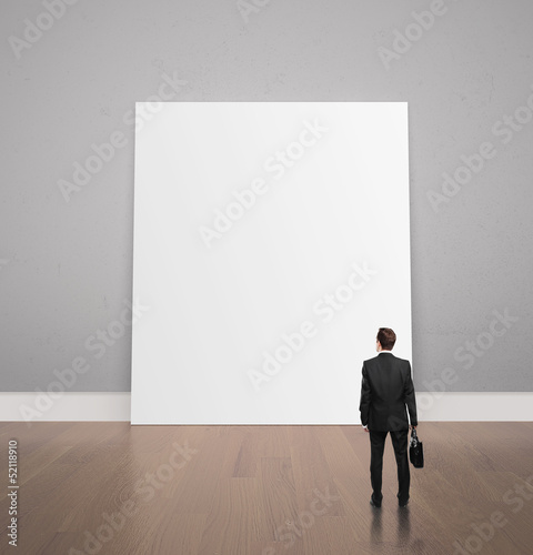 Photo: man looking at poster man looking at poster
