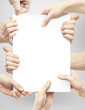 many hands holding paper